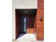 Front entry door with sleek design, modern lighting and a covered porch, enhancing curb appeal at 241 N Front St # 103, Monument, CO 80132