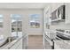 Bright kitchen showcasing granite counters, white cabinetry, stainless appliances, and views of the mountains at 241 N Front St # 103, Monument, CO 80132