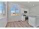 Modern kitchen with white cabinets, stainless steel appliances, granite countertops, and bright natural light at 241 N Front St # 103, Monument, CO 80132