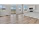 Bright living room with wood floors and views of the mountains from sliding glass doors and transom windows at 241 N Front St # 103, Monument, CO 80132