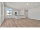 Open-concept living room and kitchen with light wood floors and a modern, minimalist design at 241 N Front St # 103, Monument, CO 80132