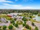 Stunning aerial view of the community with a lake, clubhouse, and vibrant landscaping on a sunny day at 18056 E 104Th Way, Commerce City, CO 80022