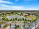 Scenic aerial view of a community with a lake, park, and recreational facilities at 18056 E 104Th Way, Commerce City, CO 80022