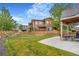Lush backyard with a concrete patio, wooden fence, and manicured lawn at 18056 E 104Th Way, Commerce City, CO 80022