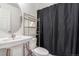 Cozy bathroom featuring a pedestal sink and a black shower curtain at 18056 E 104Th Way, Commerce City, CO 80022