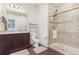 Bright bathroom with tile shower, glass door and dark wood vanity at 18056 E 104Th Way, Commerce City, CO 80022