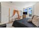 Bright bedroom with neutral walls and large windows. Includes crib and dresser at 18056 E 104Th Way, Commerce City, CO 80022