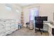 Bright bedroom with a large dresser and corner shelving unit, perfect for a home office at 18056 E 104Th Way, Commerce City, CO 80022