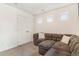 Cozy bonus room featuring a neutral gray sectional sofa and soft carpeting at 18056 E 104Th Way, Commerce City, CO 80022