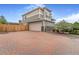 Spacious home with a two-car garage and brick paved driveway at 18056 E 104Th Way, Commerce City, CO 80022