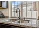 Granite countertop and stainless steel kitchen sink under bright window at 18056 E 104Th Way, Commerce City, CO 80022