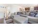 Open concept living area with dark hardwood floors and a stylish sectional sofa at 18056 E 104Th Way, Commerce City, CO 80022