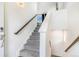 Well-lit staircase with carpeted steps and wooden handrail at 18056 E 104Th Way, Commerce City, CO 80022