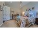 Well-lit bedroom with neutral walls, a crib, and a cozy floral bedspread at 10646 Winding Pine Pt, Highlands Ranch, CO 80126