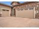 Spacious three-car garage with a charming brick exterior and a well-manicured driveway at 10646 Winding Pine Pt, Highlands Ranch, CO 80126