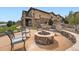 Cozy outdoor firepit area with stone surround and comfortable seating at 10646 Winding Pine Pt, Highlands Ranch, CO 80126