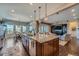 Open kitchen with a granite island, pendant lighting, and a view into the living room at 10646 Winding Pine Pt, Highlands Ranch, CO 80126