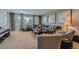 Spacious living room with large windows, neutral tones, and comfortable seating, creating a welcoming and relaxing atmosphere at 10646 Winding Pine Pt, Highlands Ranch, CO 80126
