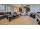 Inviting living room with plush seating, a dark wood coffee table, and elegant decor, creating a comfortable and stylish space at 10646 Winding Pine Pt, Highlands Ranch, CO 80126