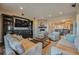 Cozy living room with a stone fireplace, built-in shelving, and plush seating at 10646 Winding Pine Pt, Highlands Ranch, CO 80126