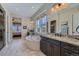 Main bathroom with granite countertops, dual sinks, soaking tub, and a separate glass-enclosed shower at 10646 Winding Pine Pt, Highlands Ranch, CO 80126