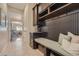 Mud room featuring a built-in bench, coat hooks, storage drawers, and tile flooring at 10646 Winding Pine Pt, Highlands Ranch, CO 80126