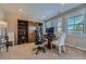 Bright office space with built-in shelving, large windows, and ample desk space at 10646 Winding Pine Pt, Highlands Ranch, CO 80126