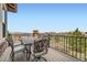 Open-air patio with wrought iron table and seating overlooking scenic neighborhood at 10646 Winding Pine Pt, Highlands Ranch, CO 80126