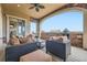 Inviting covered patio with a built-in grill, stone accents, and stylish wicker furniture perfect for outdoor entertaining at 10646 Winding Pine Pt, Highlands Ranch, CO 80126