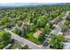 An aerial view captures this home in a neighborhood full of mature trees with mountain views in the background at 12162 W Dakota Dr, Lakewood, CO 80228