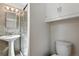 Updated bathroom featuring a pedestal sink, glass-enclosed shower, and tile surround at 12162 W Dakota Dr, Lakewood, CO 80228
