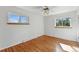 Bright bedroom with hardwood floors, two windows, ceiling fan and white walls at 12162 W Dakota Dr, Lakewood, CO 80228