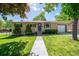 Charming ranch-style home with a well-manicured lawn and a welcoming front entrance at 12162 W Dakota Dr, Lakewood, CO 80228