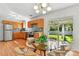 Eat-in kitchen boasting wood cabinets, stainless steel appliances, and backyard views at 12162 W Dakota Dr, Lakewood, CO 80228