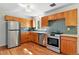 Well-equipped kitchen with stainless steel appliances, and classic wood cabinetry at 12162 W Dakota Dr, Lakewood, CO 80228