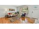 Bright living room featuring hardwood floors, a bay window, and stylish furnishings at 12162 W Dakota Dr, Lakewood, CO 80228