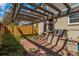 Backyard patio features a pergola, brick pavers, and privacy fence, offering a tranquil outdoor escape at 9424 E Girard Ave, Denver, CO 80231