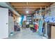 Unfinished basement provides ample storage space with wooden shelves and potential for customization at 9424 E Girard Ave, Denver, CO 80231