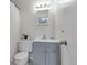 Updated bathroom with a gray vanity, modern fixtures, and a shower-tub combination with neutral decor at 9424 E Girard Ave, Denver, CO 80231