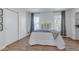 Cozy bedroom with light-colored bedding, soft natural light, and spacious closet, designed for comfort and relaxation at 9424 E Girard Ave, Denver, CO 80231