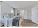 Bright bedroom showcasing a plush bed, ample closet space, and a glimpse of the ensuite bathroom at 9424 E Girard Ave, Denver, CO 80231