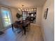 Dining room with stylish chandelier, modern table set, and adjacent mirror reflecting natural light at 9424 E Girard Ave, Denver, CO 80231