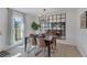 Dining area featuring a modern chandelier, dark wood table, and stylish chairs, perfect for entertaining guests at 9424 E Girard Ave, Denver, CO 80231