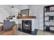 Close up of a modern fireplace with a wooden mantle, adding warmth and character to the living space at 9424 E Girard Ave, Denver, CO 80231