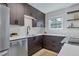 Stylish kitchen showcasing sleek countertops, dark cabinets, and modern fixtures for a sophisticated design at 9424 E Girard Ave, Denver, CO 80231