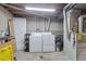 Unfinished basement laundry room with washer, dryer, and utility sink at 9424 E Girard Ave, Denver, CO 80231