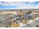 Aerial view showcasing a home with solar panels, a two-car garage, and a manicured front lawn at 3764 Balderas St, Brighton, CO 80601