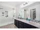 The luxurious bathroom features a spacious shower, dual sinks, and modern fixtures for a spa-like experience at 3764 Balderas St, Brighton, CO 80601