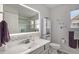 Bright bathroom featuring updated vanity, stylish mirror, and decorative wall art at 3764 Balderas St, Brighton, CO 80601