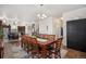 Bright dining room with modern chandelier, wood flooring, and access to kitchen and other rooms at 3764 Balderas St, Brighton, CO 80601
